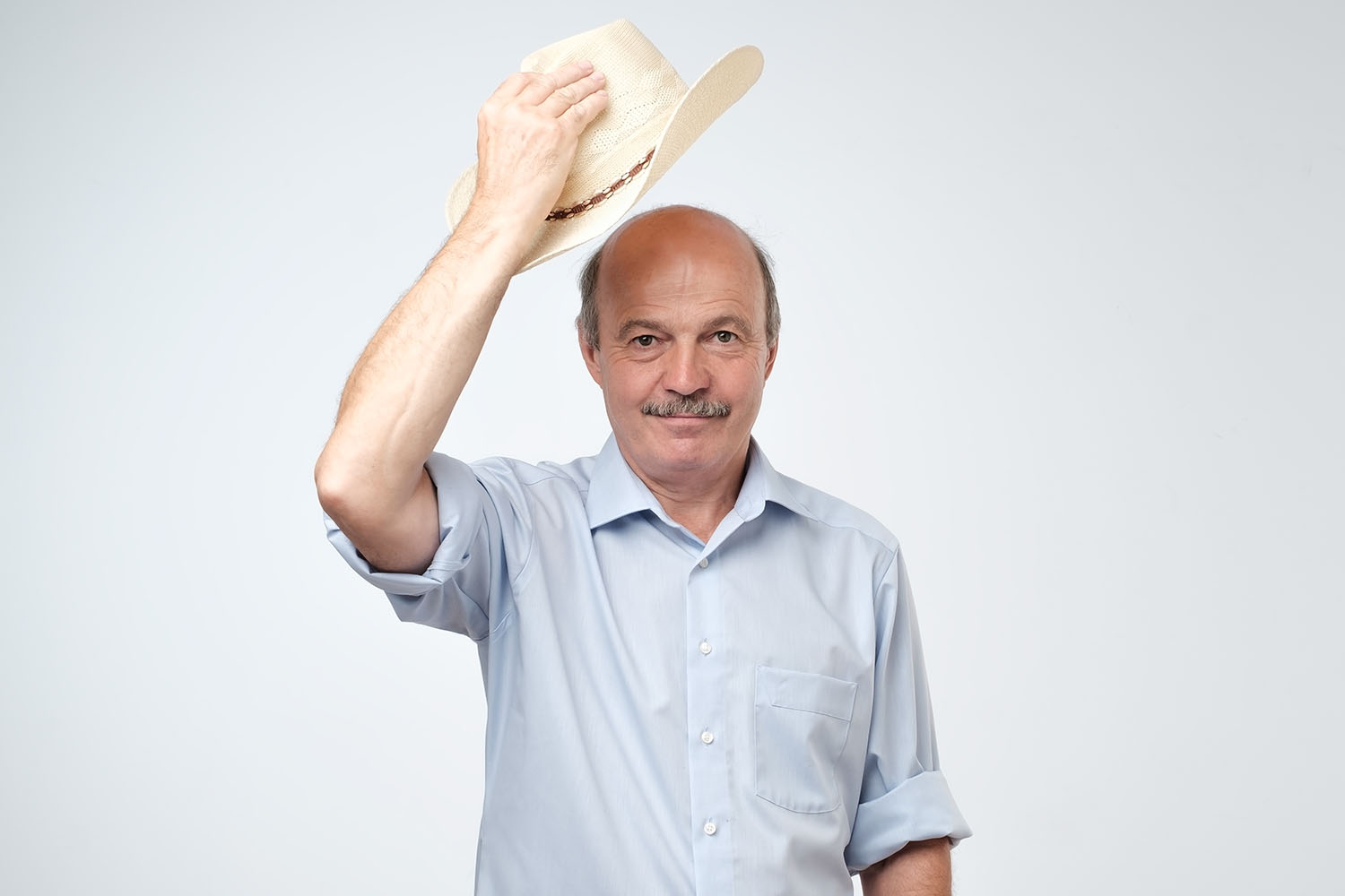 mature man waving with cowboy hat studio welcoming his guests Bojanini Colombia